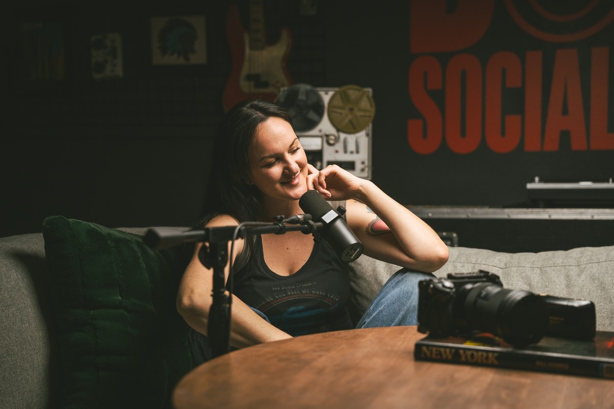 Brianna of Dork Social Club talking into a podcast mic in the studio